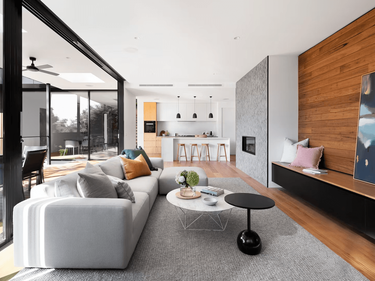 Completed open-plan living and kitchen renovation with timber feature wall