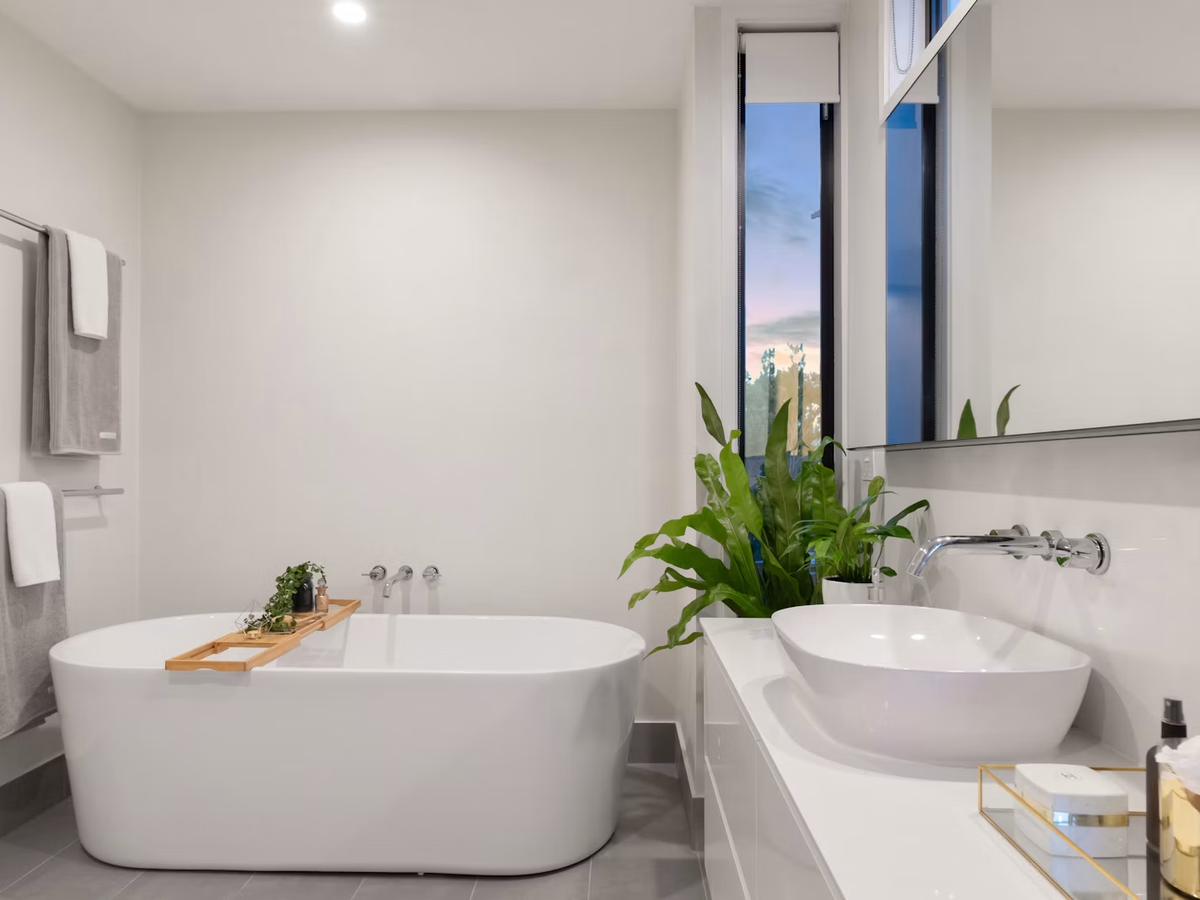 Renovated bathroom with freestanding tub, vessel basin and wall-mounted fixtures