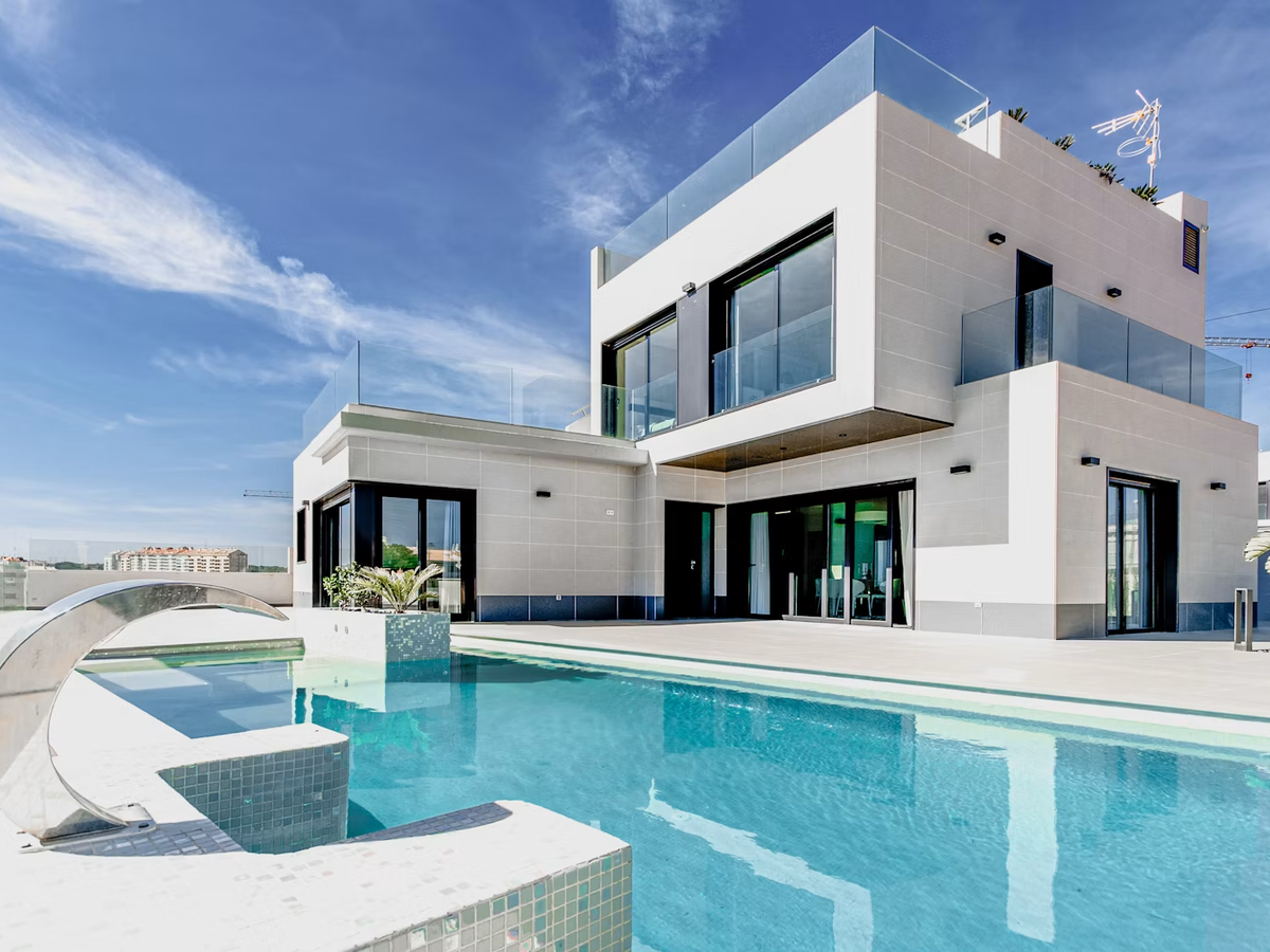 Modern home exterior with new cladding, glass balustrades and pool terrace
